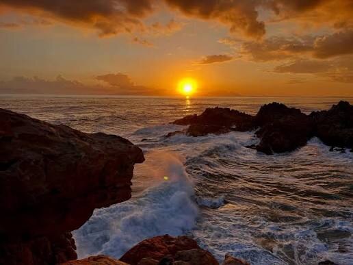 Golden sunset over the rocks at De Kelders