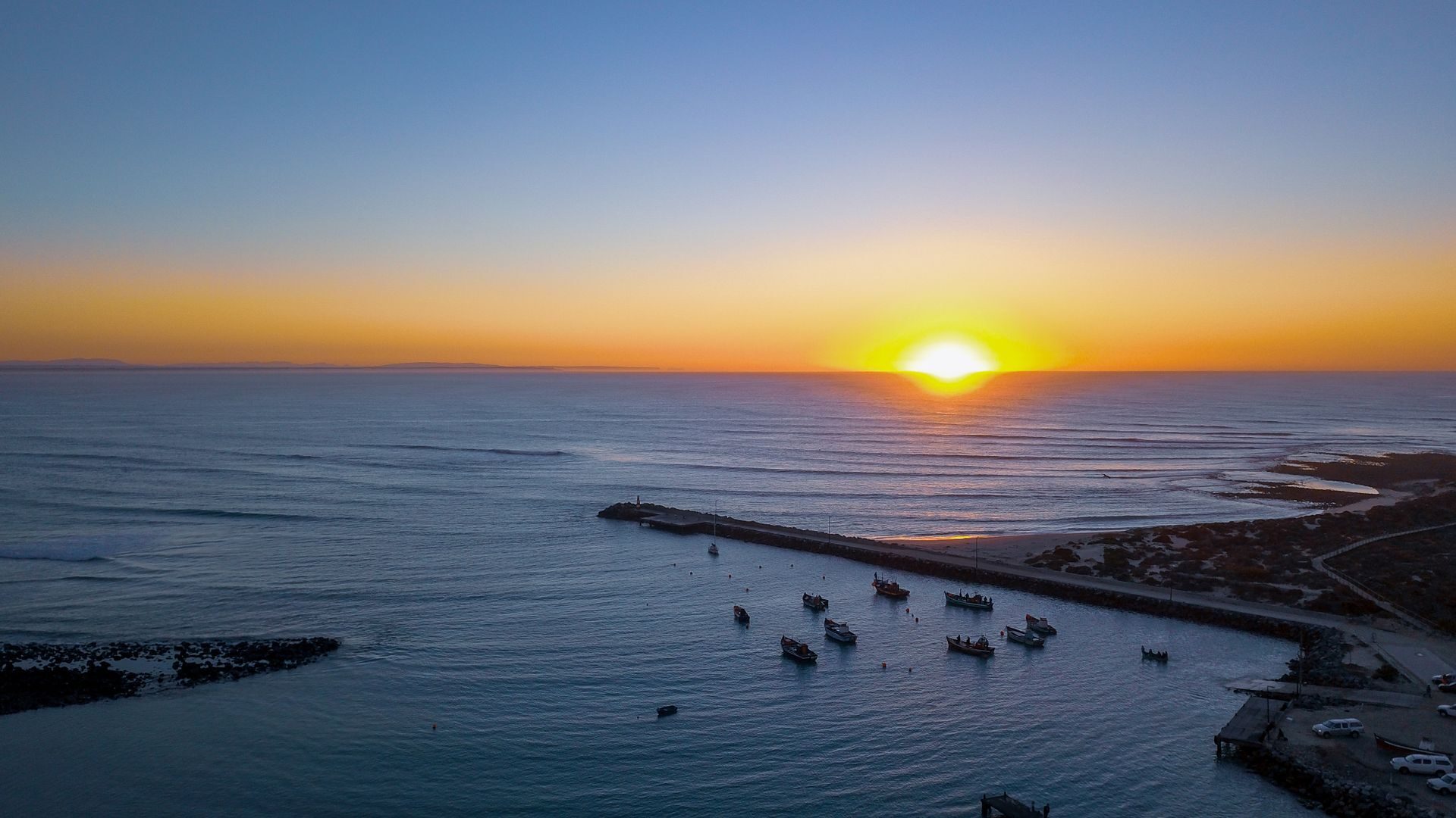 Small boats moored in a quiet harbour at golden hour